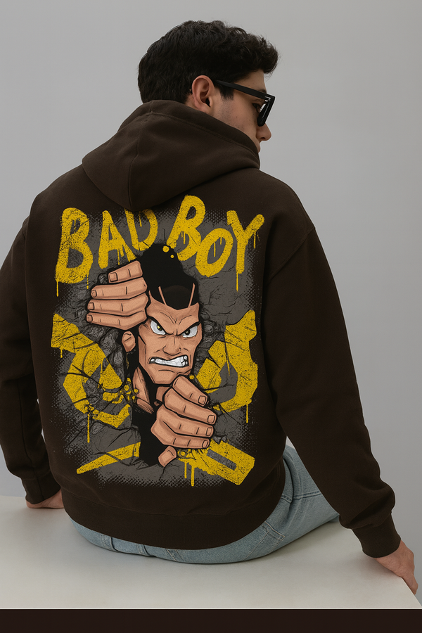 Oversized brown hoodie with a graphic print of a man breaking through a wall.