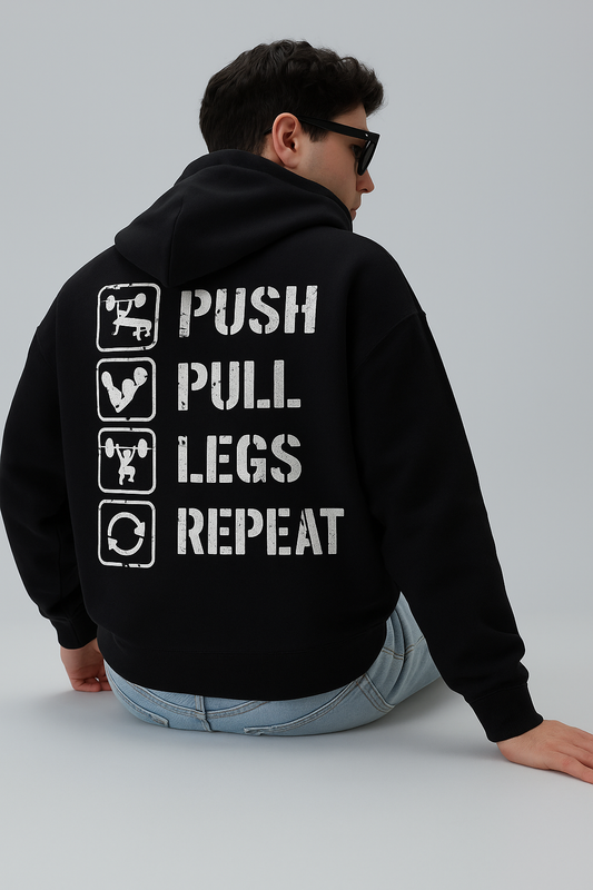Men's black oversized hoodie with "Push Pull Legs Repeat" graphic.