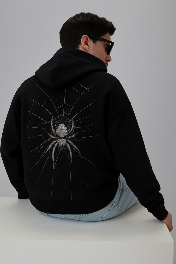 Black oversized hoodie with a spiderweb and spider graphic on the back.