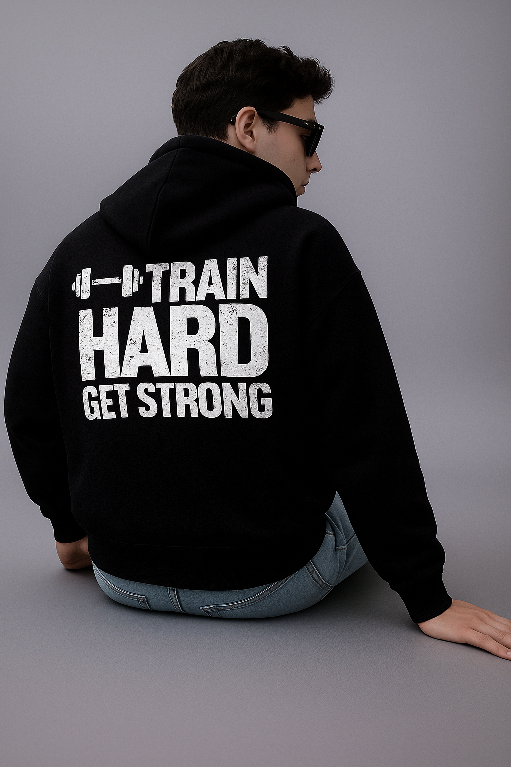 Black oversized hoodie with "Train Hard Get Strong" graphic.